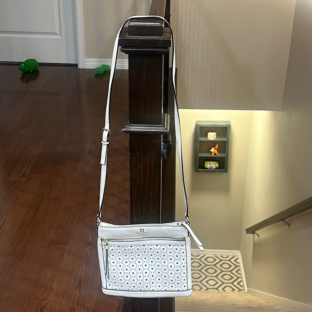 Kate Spade white leather bag with cutouts.